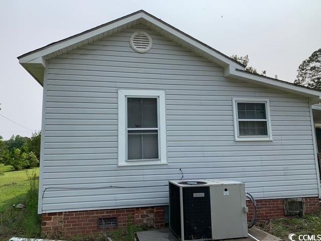 View of side of property featuring crawl space and central AC unit | Image 22