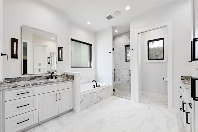 Bathroom with vanity, a marble finish shower, recessed lighting, a garden tub, and marble finish floor | Image 16