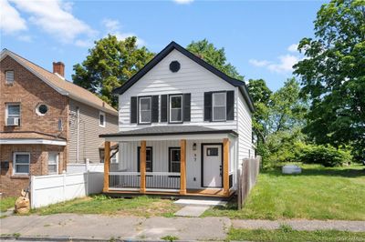 View of front facade with a front lawn, cooling unit, and covered porch | Image 3