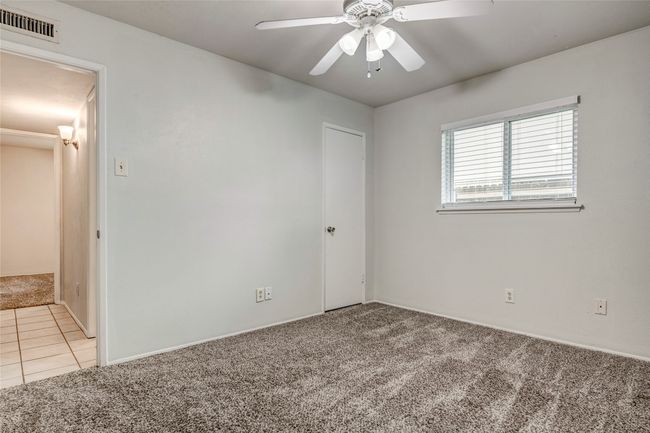 Tiled spare room featuring carpet floors, ceiling fan, and baseboards | Image 28