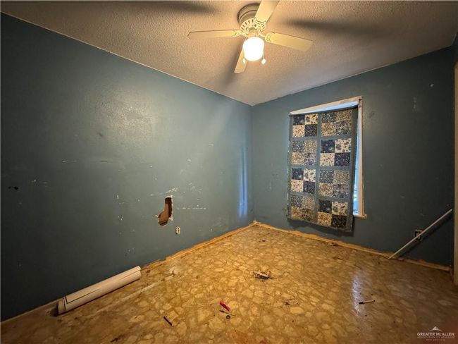 Spare room with a textured ceiling and a ceiling fan | Image 11