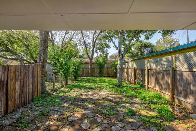 Fenced backyard with a storage shed and an outbuilding | Image 34