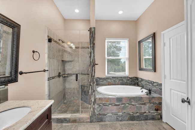 Bathroom featuring a garden tub, vanity, a shower stall, and recessed lighting | Image 20