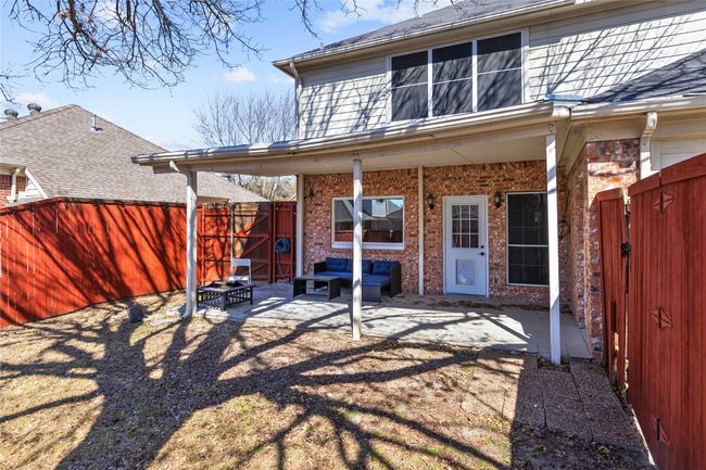 Back of house with a patio, a fenced backyard, brick siding, and an outdoor living space | Image 17