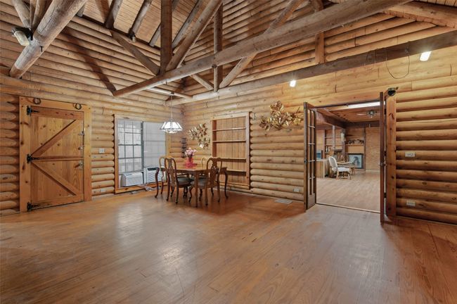 Dining area and family room looking into the main living room. | Image 5