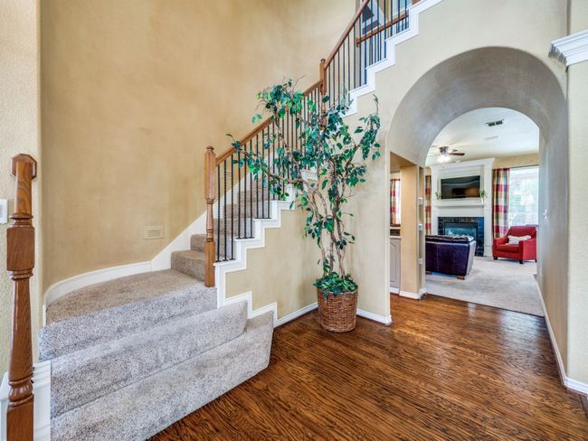 Grand entry with hardwood floors and sweeping staircase. | Image 5