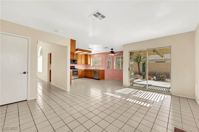 Unfurnished living room with ceiling fan, light tile patterned flooring, visible vents, and baseboards | Image 18