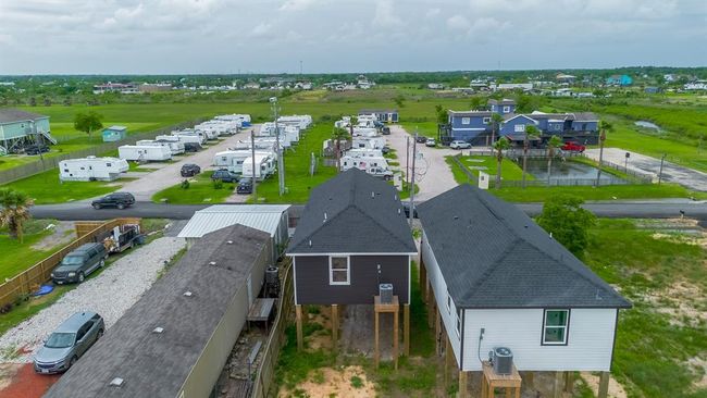 From behind, the elevated home overlooks the neighboring trailer park and beyond, toward stretches of greenery and undeveloped land. | Image 33