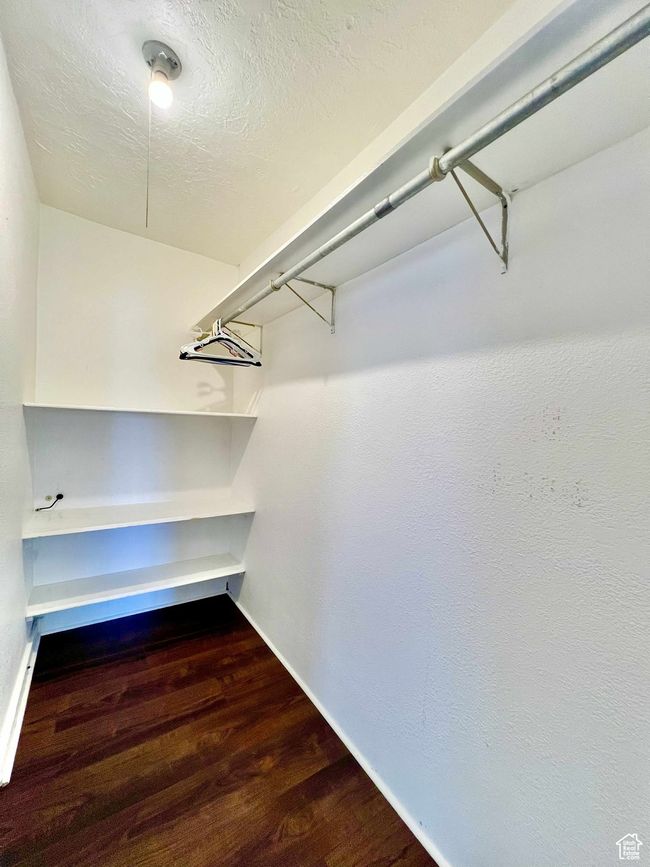 Spacious closet with wood finished floors | Image 24