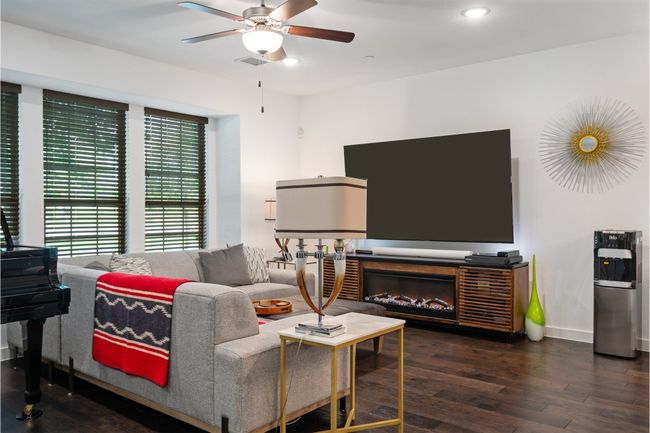 Living room with a ceiling fan, wood finished floors, baseboards, and recessed lighting | Image 12