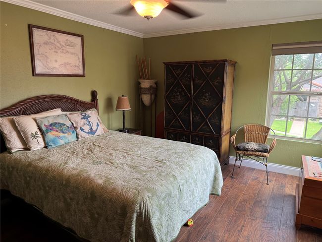 Bedroom with hardwood / wood-style flooring, ornamental molding, and ceiling fan | Image 8