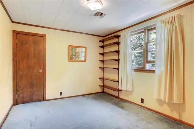 Spare room with crown molding and carpet | Image 6