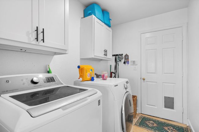Washroom featuring separate washer and dryer and cabinet space | Image 34