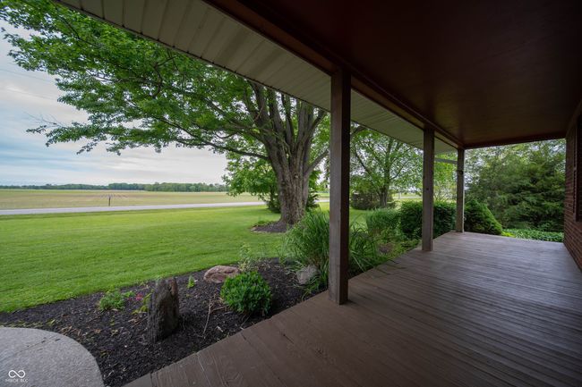 wooden deck featuring a yard and a view of countryside | Image 6