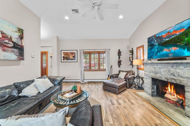 Family room , a ceiling fan, wood finished floors, a stone fireplace, and lofted ceiling | Image 20
