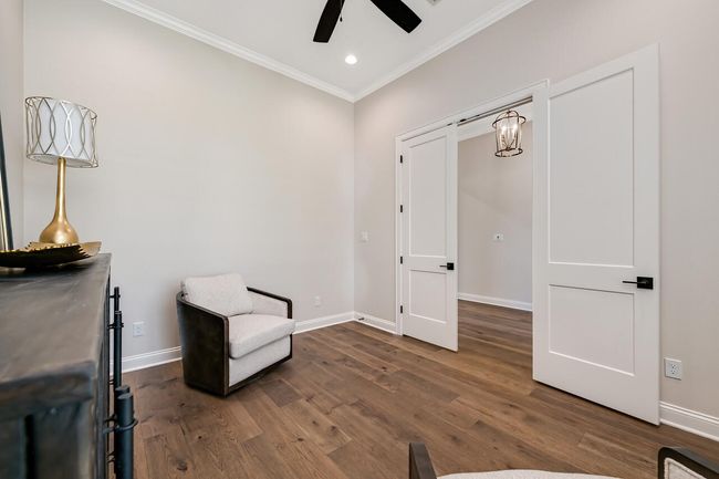 Unfurnished room featuring crown molding, ceiling fan, dark wood finished floors, and recessed lighting | Image 10