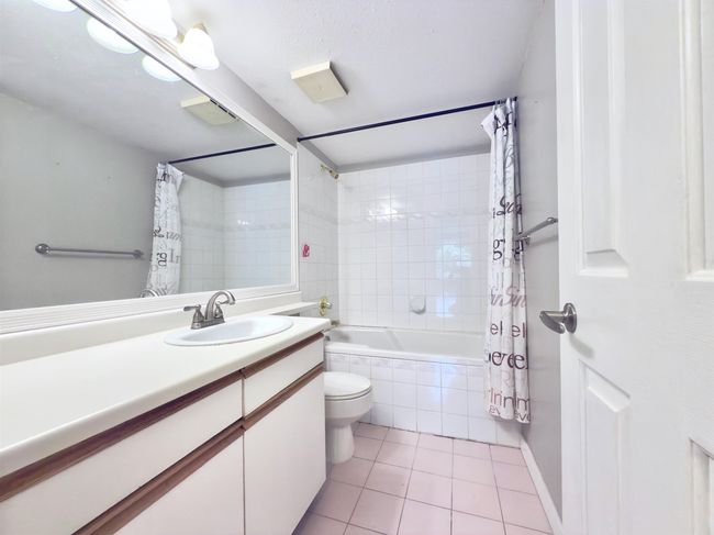 Bathroom featuring tile patterned flooring, vanity, toilet, and tiled shower / bath | Image 10