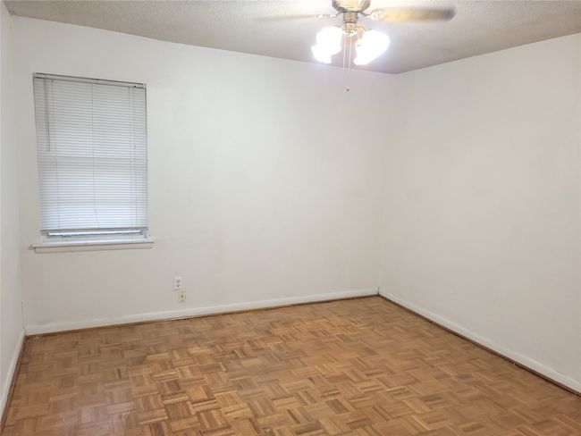 Empty room featuring ceiling fan, baseboards, and a textured ceiling | Image 14