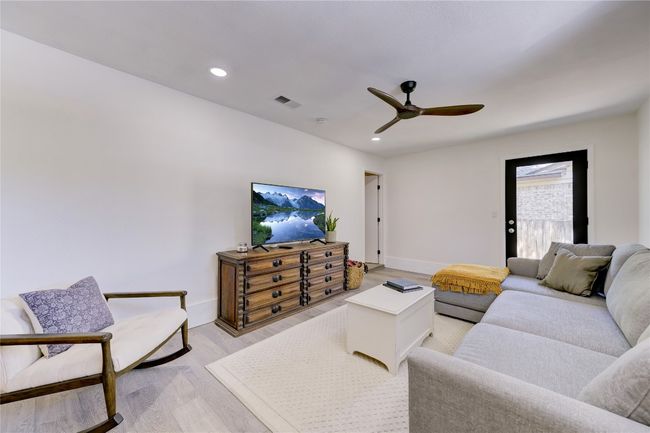 Living room featuring a ceiling fan, visible vents, recessed lighting, light wood finished floors, and baseboards | Image 11