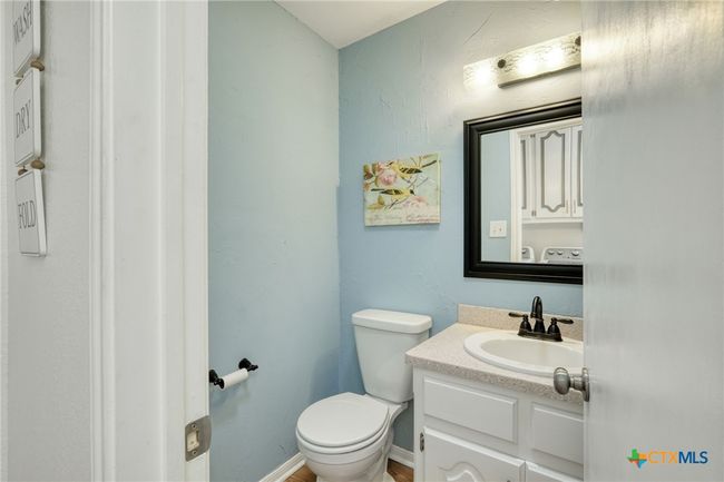 Half-bath located near the back door leading to the patio or the garage. | Image 16