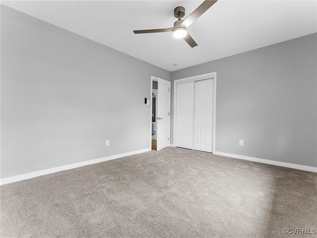 Unfurnished bedroom featuring carpet floors, a closet, a ceiling fan, and baseboards | Image 30