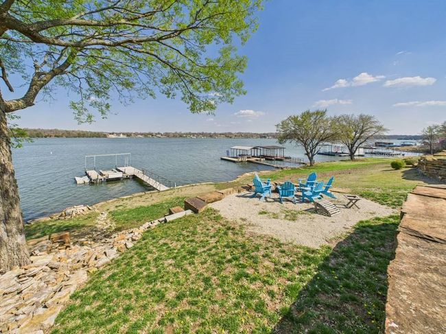 Dock area with a water view and an outdoor fire pit | Image 9