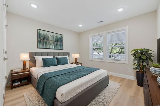 Bedroom featuring light wood-type flooring, baseboards, and recessed lighting | Image 19