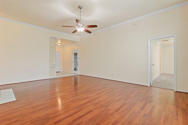 View from the family room looking into the front entry and the primary bedroom. | Image 8