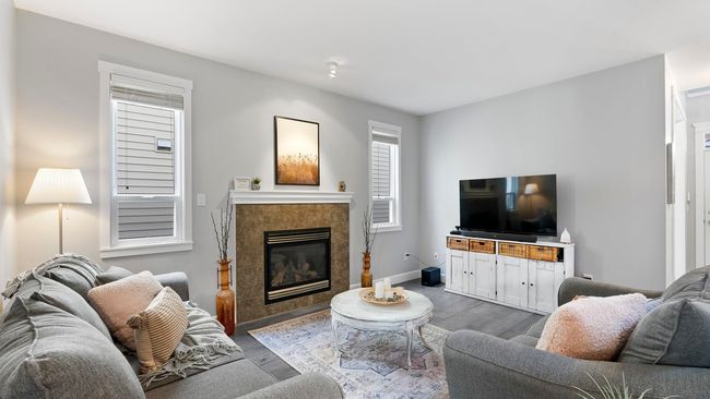 Living area featuring baseboards, a tile fireplace, and wood finished floors | Image 4