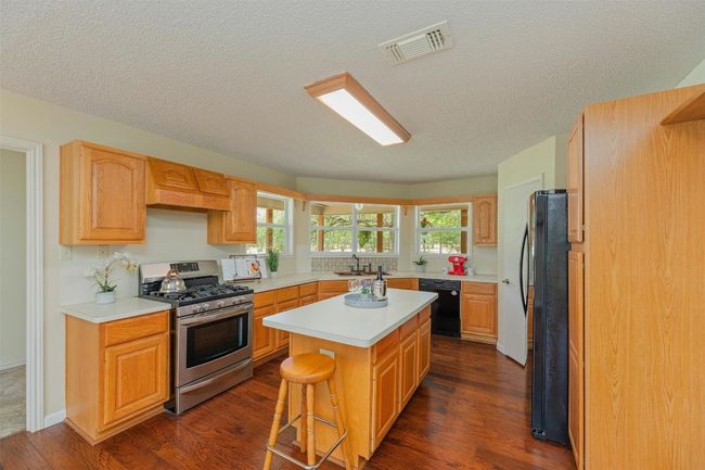 Spacious kitchen with great views out of the window into the canopy of trees. | Image 12