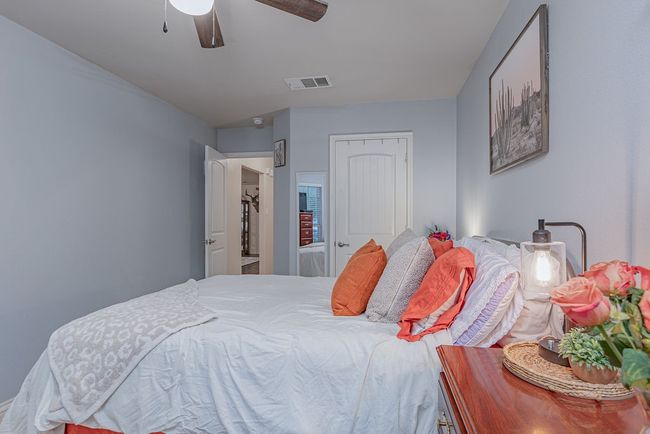Bedroom with visible vents, a closet, and a ceiling fan | Image 5