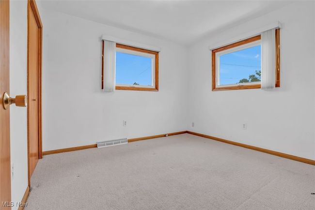 Empty room featuring plenty of natural light, carpet, and baseboards | Image 16