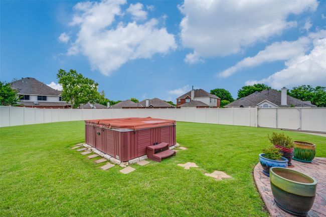 Huge back yard with hot tub and gated vinyl fence | Image 31