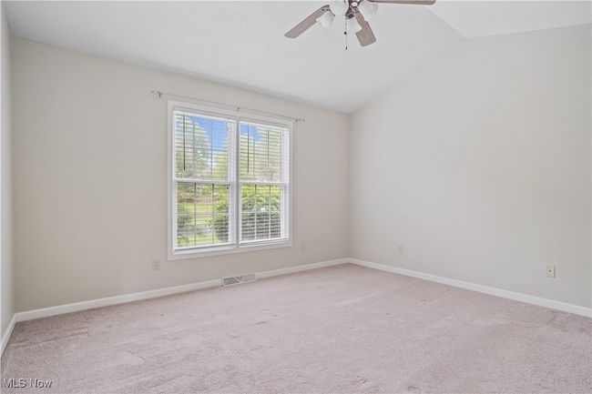 Empty room featuring vaulted ceiling, ceiling fan, light carpet, and baseboards | Image 10