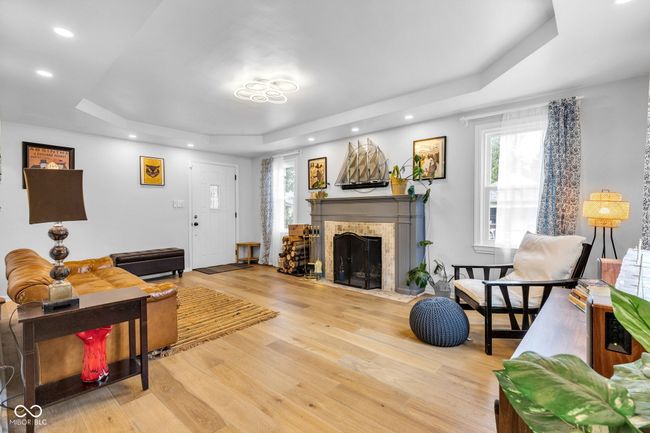 Visual reference from the central dining area to the front living room and fireplace. | Image 4