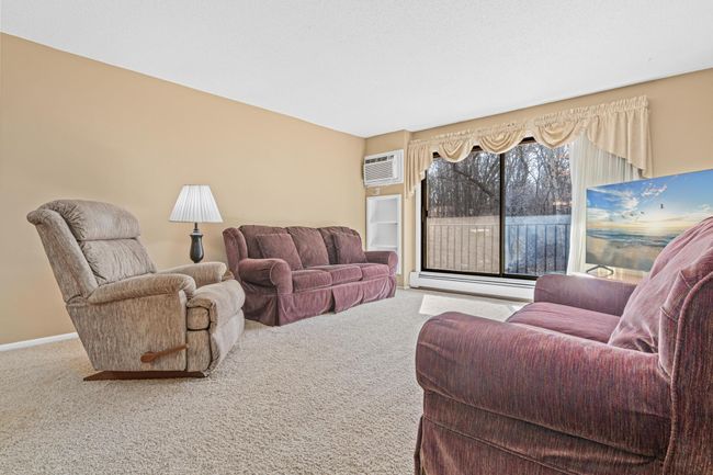 Living Room Featuring Sliding Glass Door & Balcony Views | Image 9