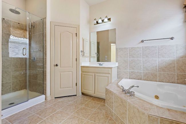 Full bath with vanity, a jetted tub, and a shower stall | Image 21
