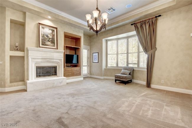 Unfurnished room with ornamental molding, built in features, a chandelier, and baseboards | Image 26