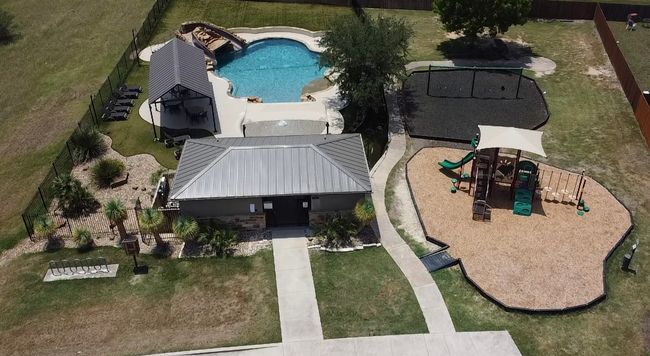 The neighborhood is fully stocked with amenities including a playground and a swimming pool. | Image 27