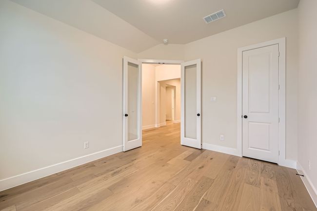 Unfurnished bedroom featuring baseboards, light wood-style flooring, and visible vents | Image 13