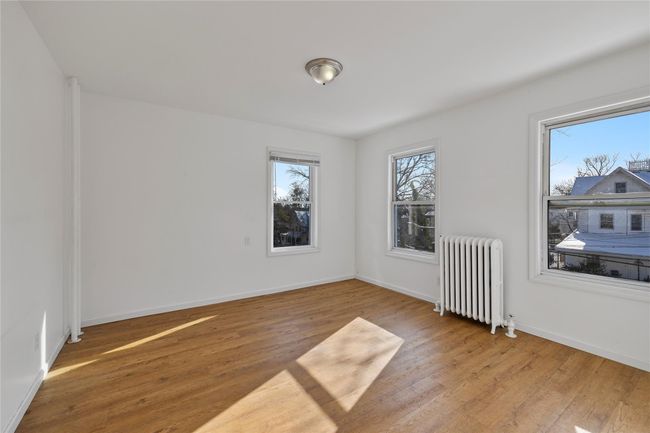Unfurnished room featuring radiator and light hardwood / wood-style floors | Image 16