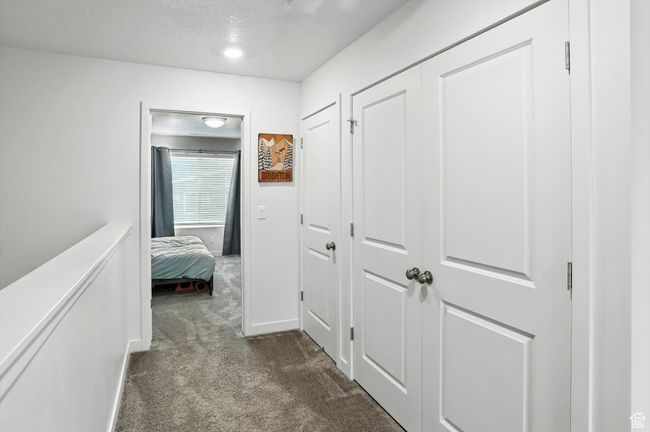 Hallway featuring dark carpet | Image 33