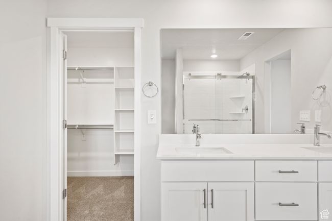 Full bath with a stall shower, double vanity, and a spacious closet | Image 36