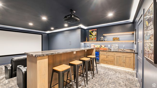 Cinema featuring light carpet, wine cooler, recessed lighting, and wet bar | Image 32