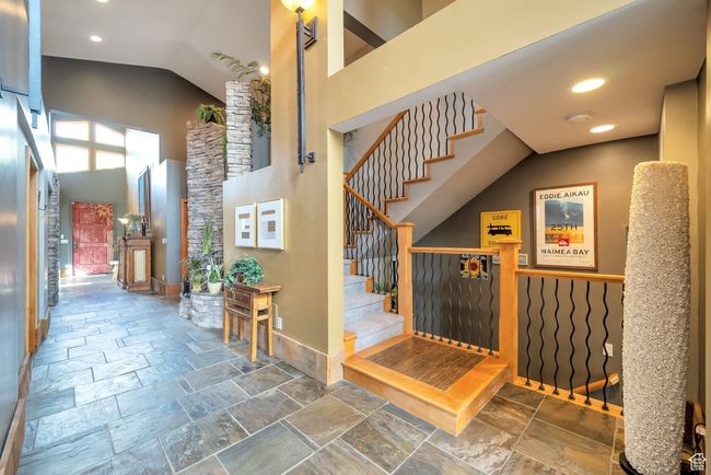 Stairway featuring stone tile floors, recessed lighting, high vaulted ceiling, and baseboards | Image 29