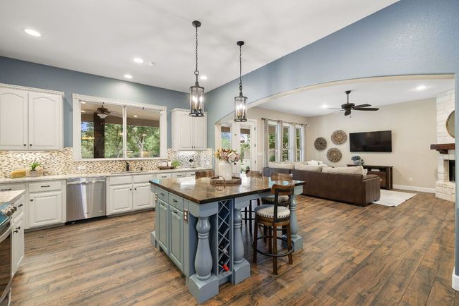Country kitchen opens to the family room. | Image 8