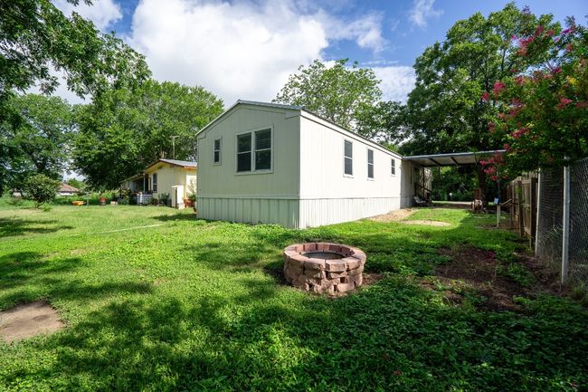 View of yard with a fire pit and a carport | Image 31