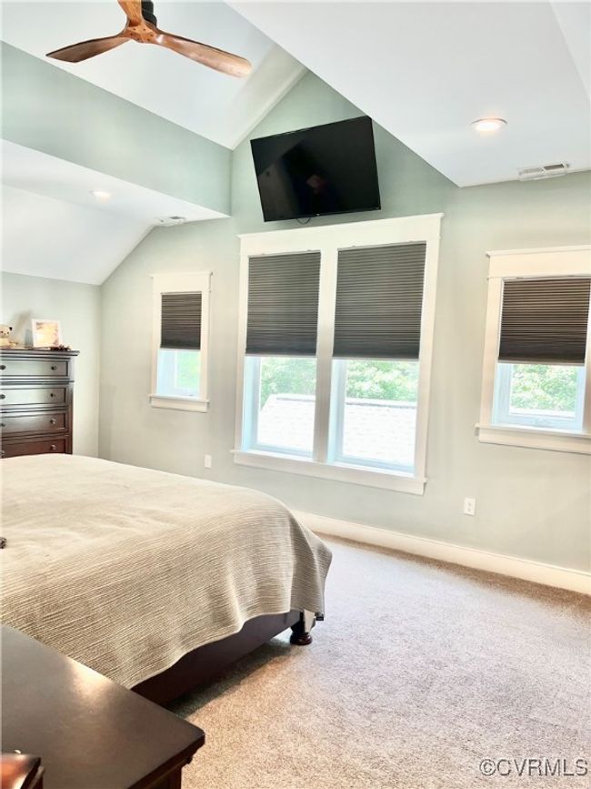 Carpeted Upstairs Primary bedroom with lofted ceiling and ceiling fan | Image 27