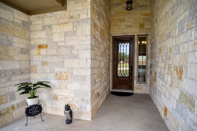 View of exterior entry featuring stone siding | Image 36