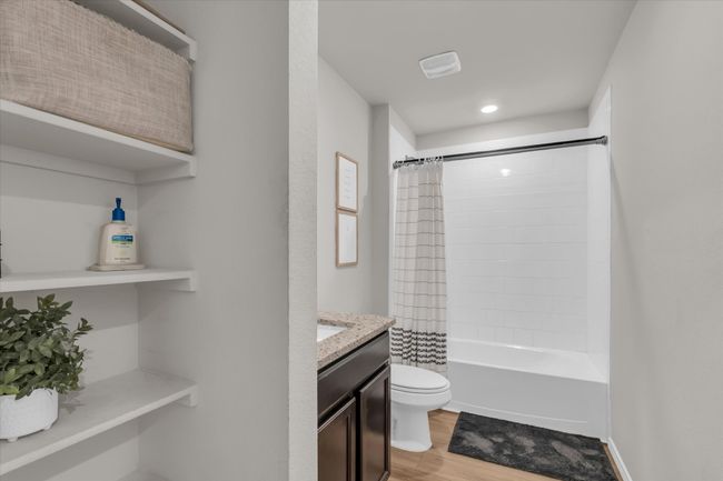 Bathroom featuring wood finished floors, toilet, recessed lighting, shower / tub combo with curtain, and vanity | Image 24